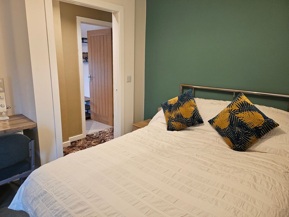 A bedroom with a bed and desk at Rockhurst Farm in Matlock