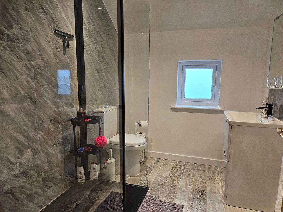 A bathroom with a shower, toilet, and sink at Rockhurst Farm Matlock