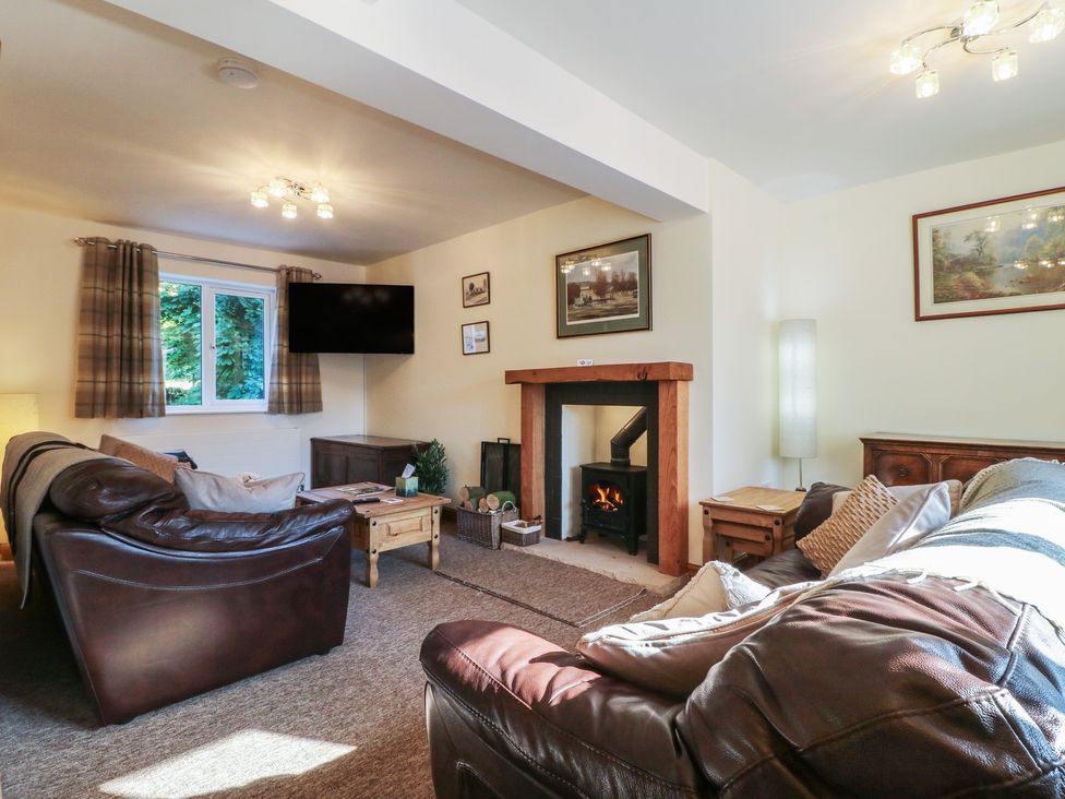 A living room with a sofa and fireplace at Rockhurst Farm near Winster