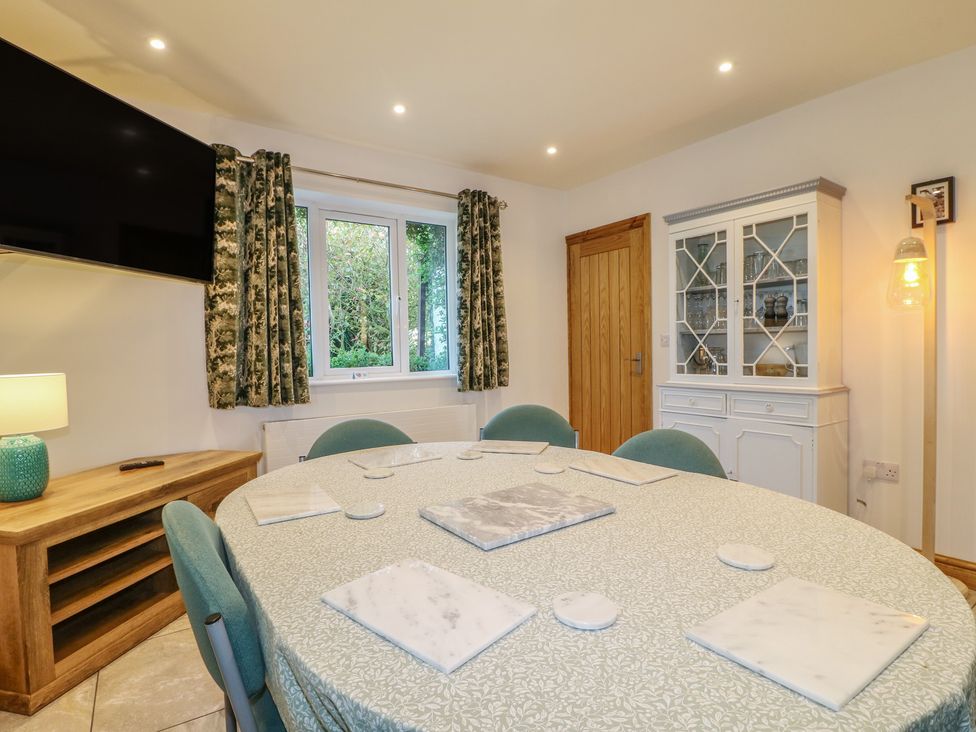 A dining room with a round table and chairs at Rockhurst Farm near Winster
