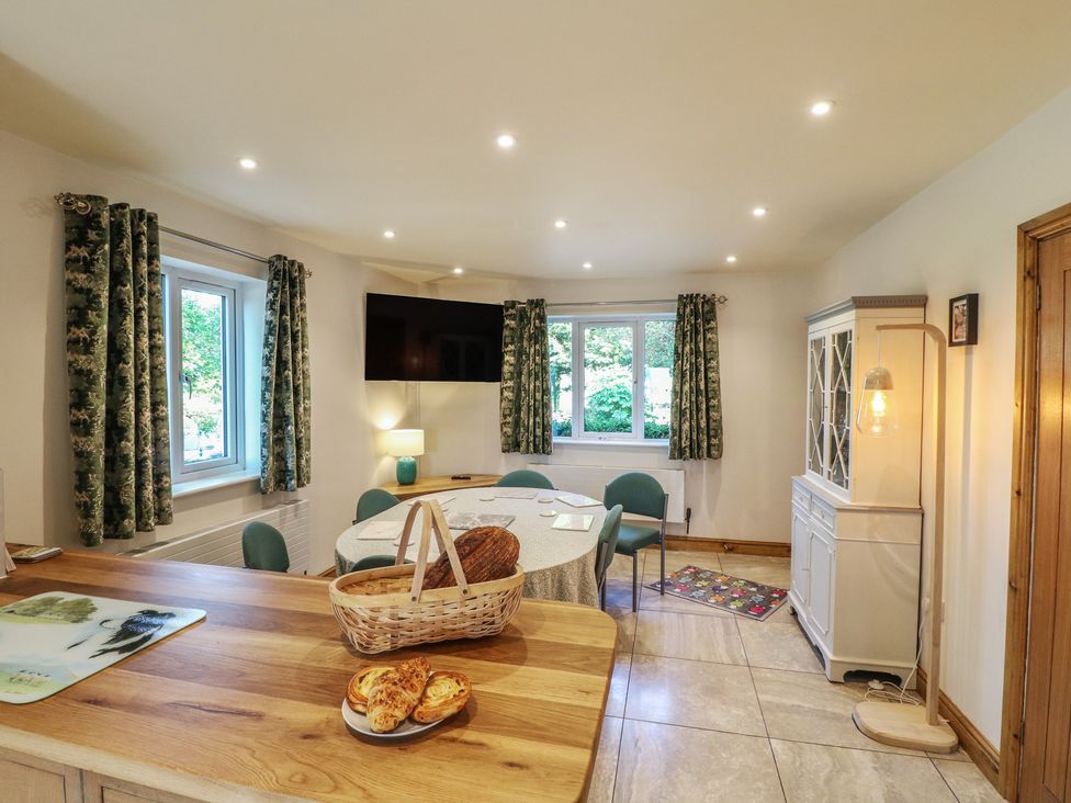A dining room with a table and chairs at Rockhurst Farm near Winster