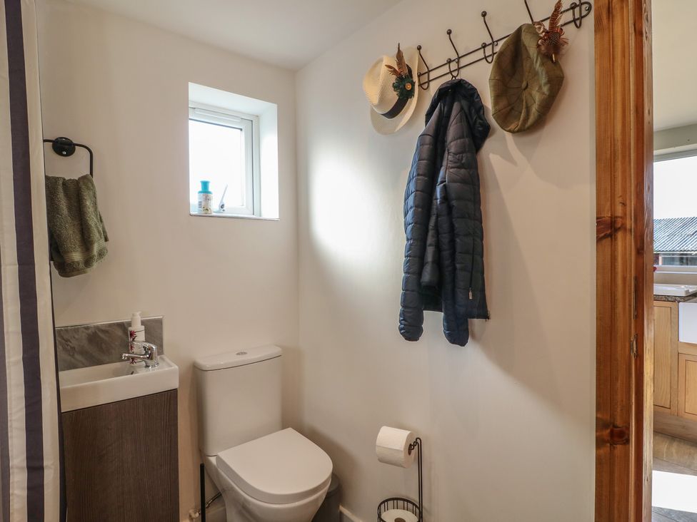 A bathroom with a toilet and sink at Rockhurst Farm near Winster