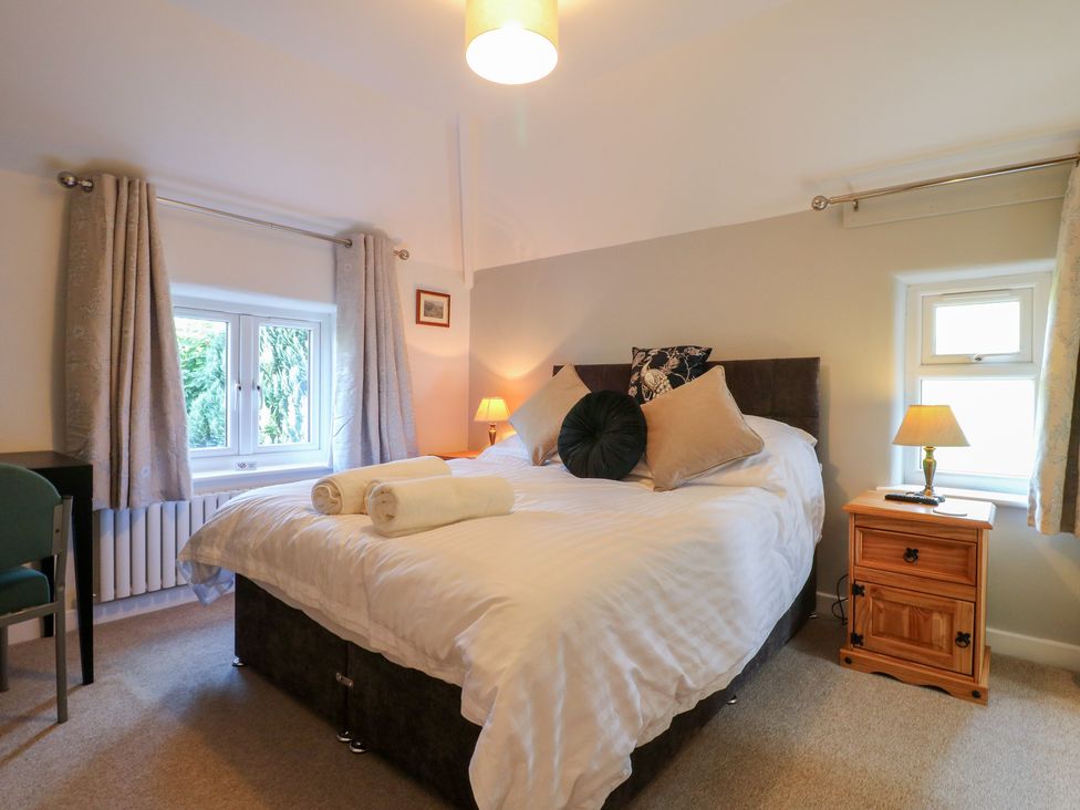 A bedroom with a bed and bedside table at Rockhurst Farm near Winster