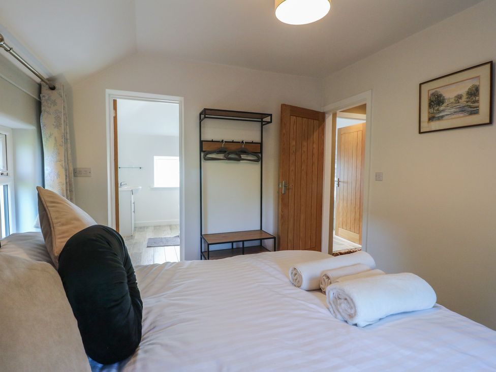 A bedroom with a bed and towels at Rockhurst Farm near Winster