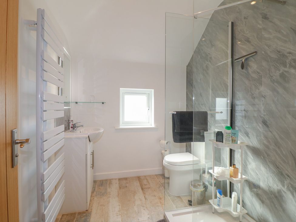 A bathroom with shower, sink, and toilet at Rockhurst Farm near Winster