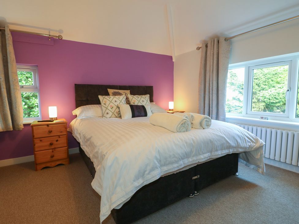 A bedroom with a bed and bedside table at Rockhurst Farm near Winster
