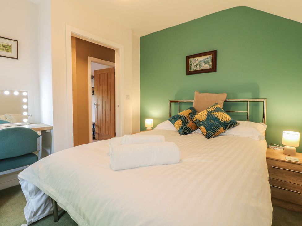 A bedroom with a bed and desk at Rockhurst Farm near Winster
