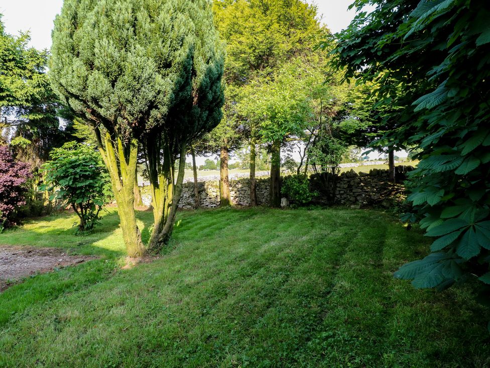 A garden with trees and grass at Rockhurst Farm near Winster