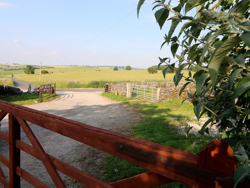 A view of a gate and gravel path leading to a field at Rockhurst Farm near Winster