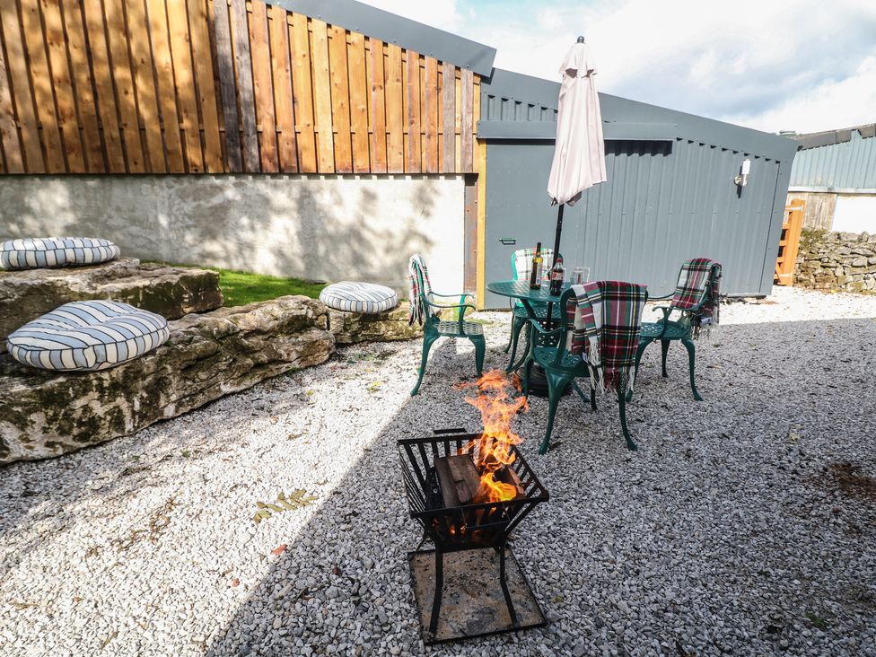 An outdoor seating area with a fire pit at Rockhurst Farm near Winster