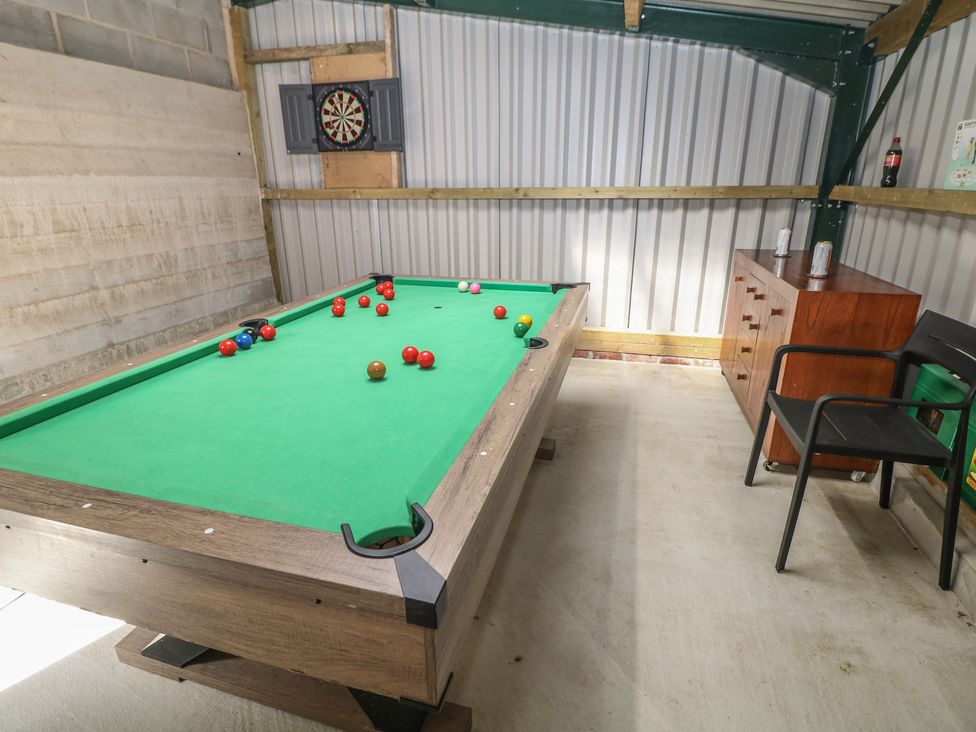 A snug with a pool table and a darts board at Rockhurst Farm near Winster