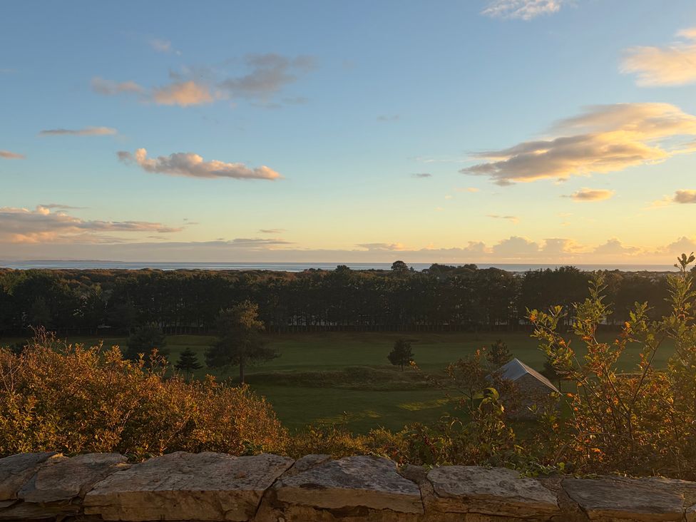 A landscape view with trees and a house at Hafod Y Graig in Morfa Bychan