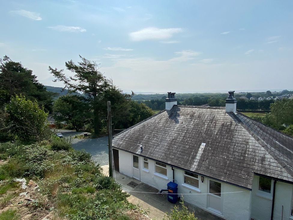 A house with a roof and trees outdoors at Hafod Y Graig in Morfa Bychan