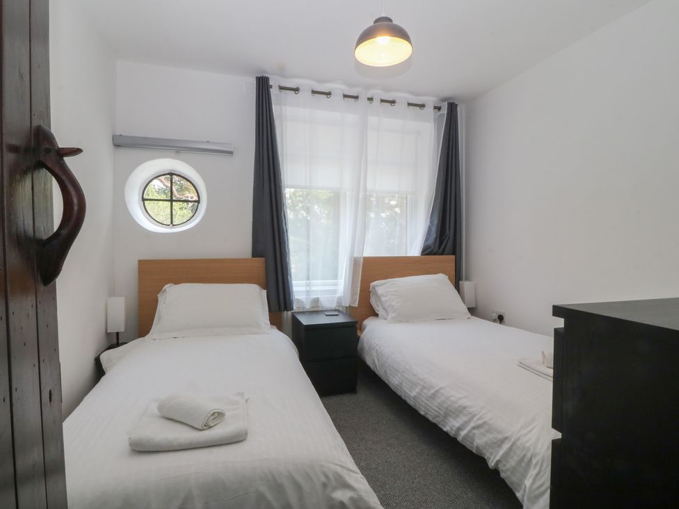 A bedroom with two beds and a window at Seaview Hafod Y Graig in Morfa Bychan
