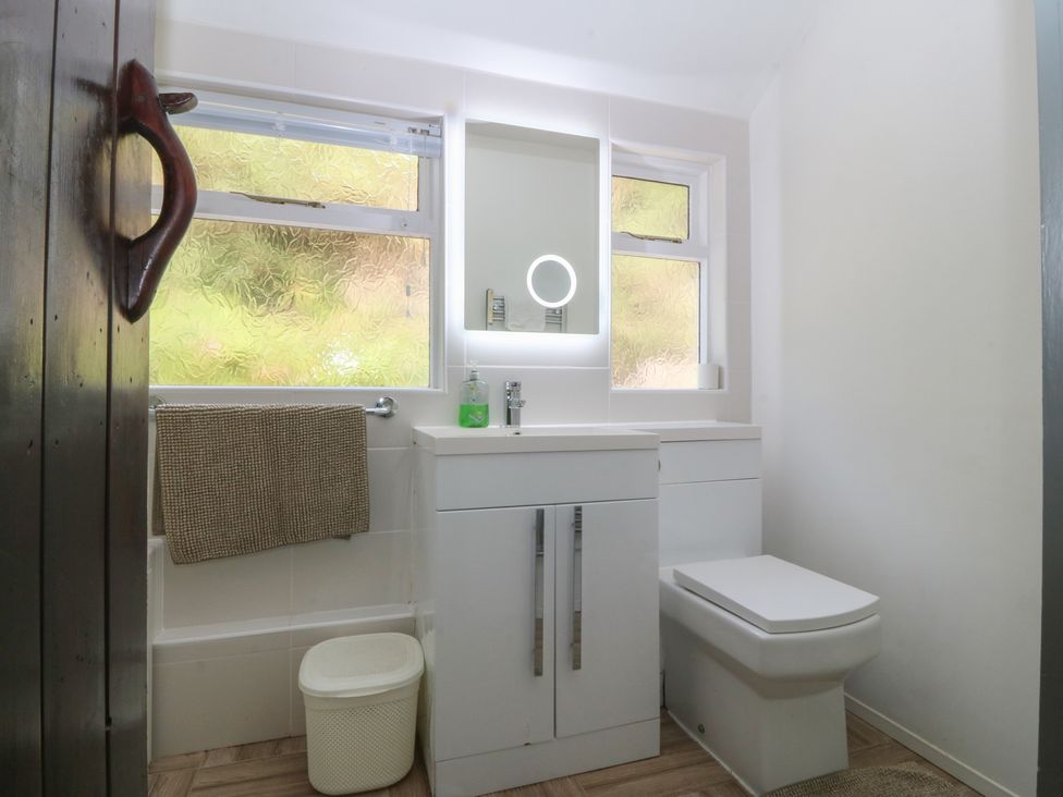 A bathroom with a sink and toilet at Seaview Hafod Y Graig Morfa Bychan