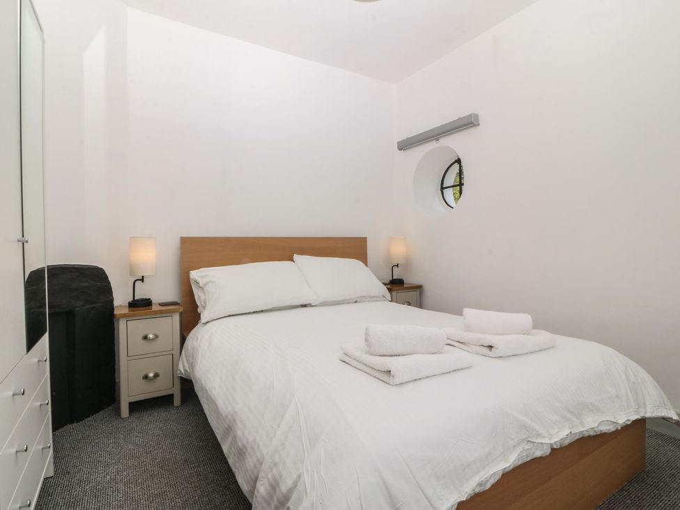 A bedroom with a bed and bedside table at Seaview Hafod Y Graig in Morfa Bychan