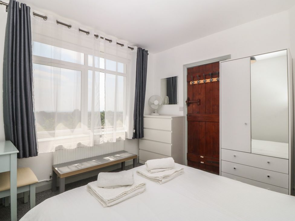 A bedroom with a bed and towels on it at Seaview Hafod Y Graig Morfa Bychan