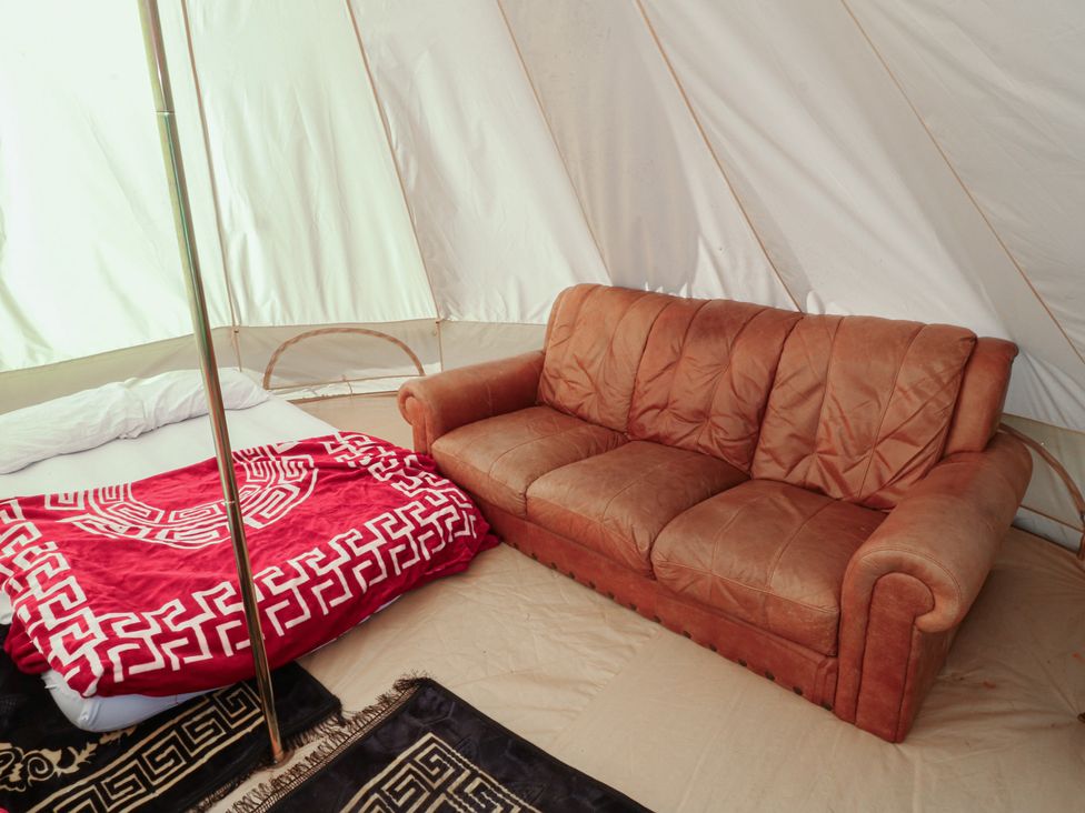 A tent with a sofa and a bed at Bell Tent Two