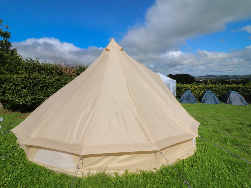 A tent in a grassy outdoor area at Bell Tent Three