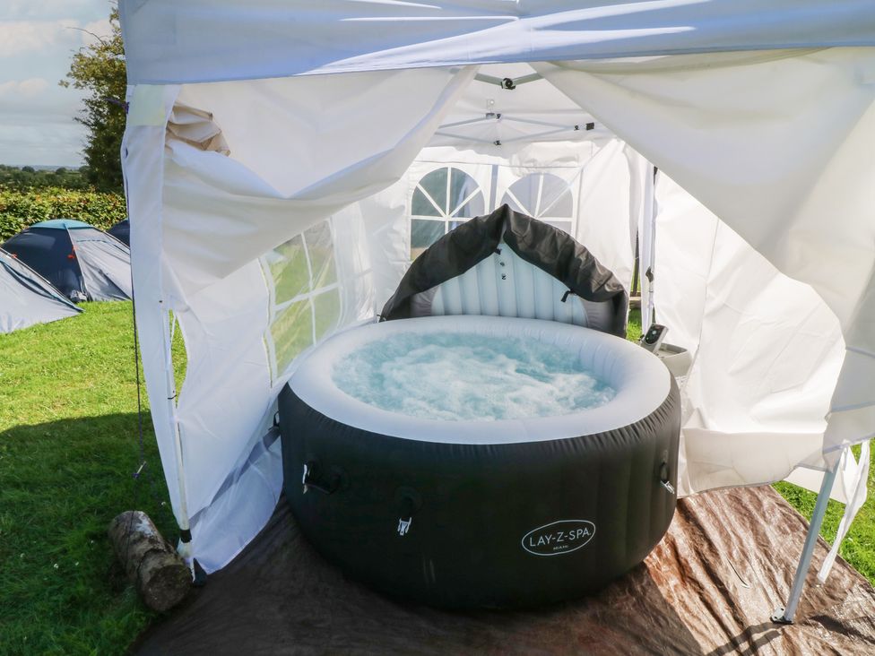 A hot tub inside a tent at Bell Tent Three