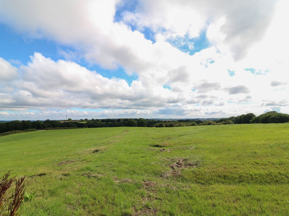 A field with grass and clouds in the sky at Bell Tent Three