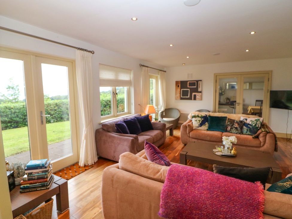A living room with sofas and a table at 25 Ring of Kerry Holiday Cottages in Kenmare