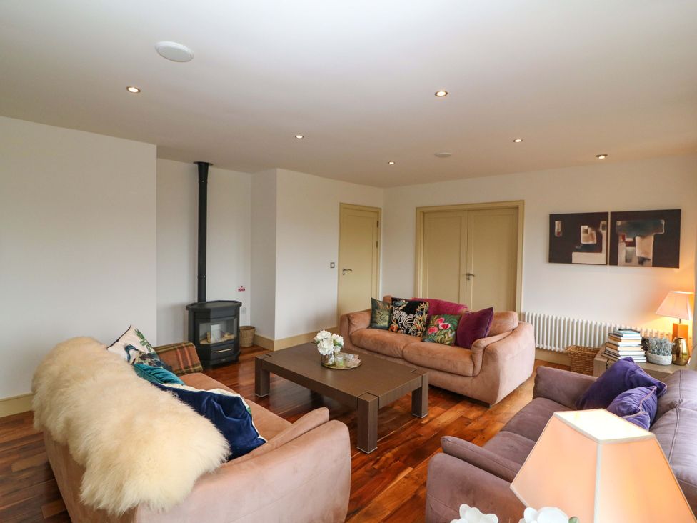 A living room with sofas and a coffee table at 25 Ring of Kerry Holiday Cottages in Kenmare