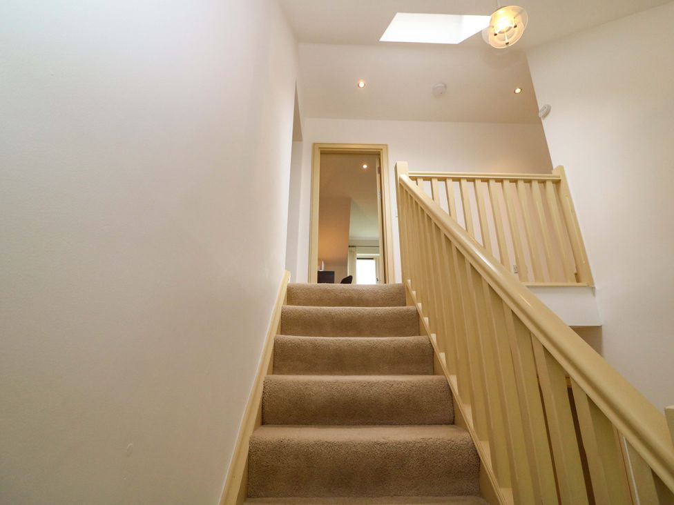 A staircase leading to a doorway at 25 Ring of Kerry Holiday Cottages in Kenmare