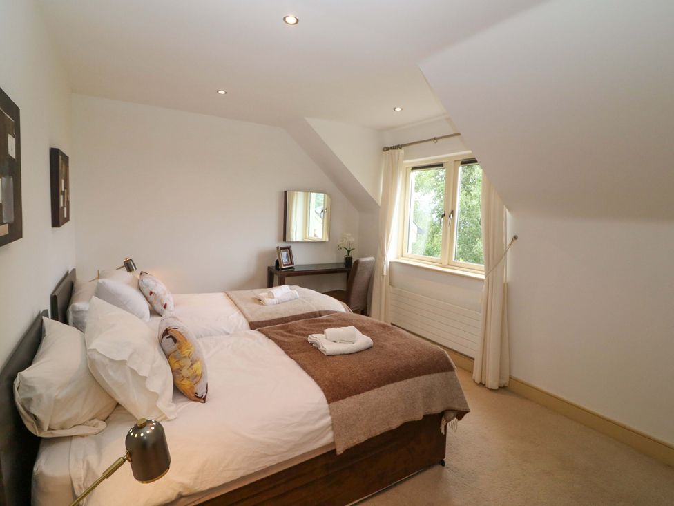 A bedroom with two beds and a desk at 25 Ring of Kerry Holiday Cottages in Kenmare