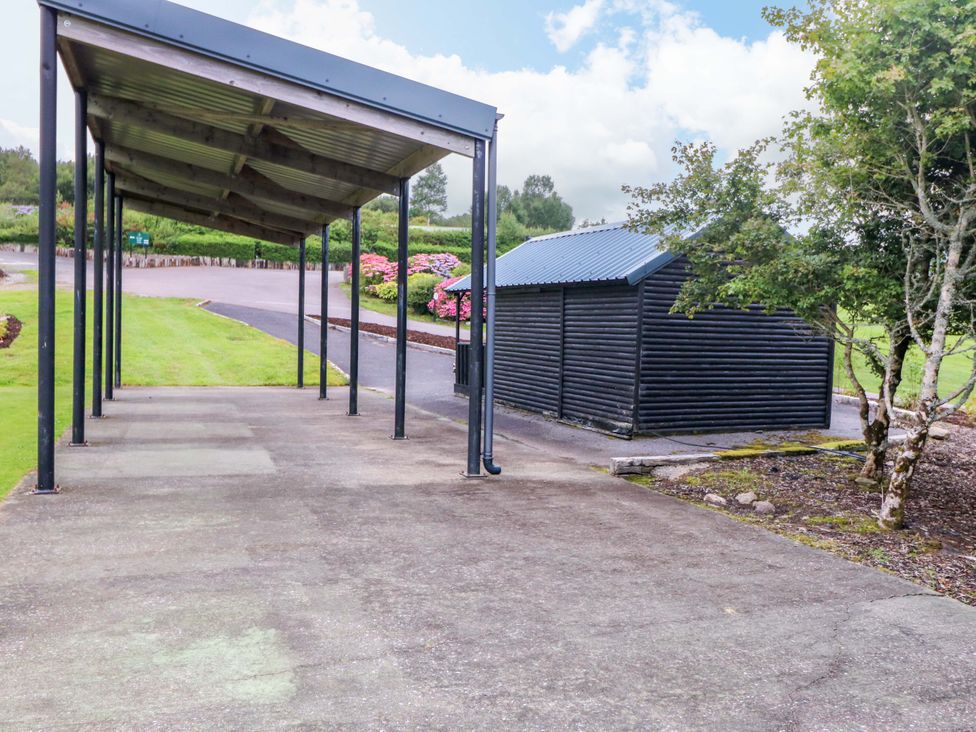 An outdoor area with a shelter and a shed at 25 Ring of Kerry Holiday Cottages