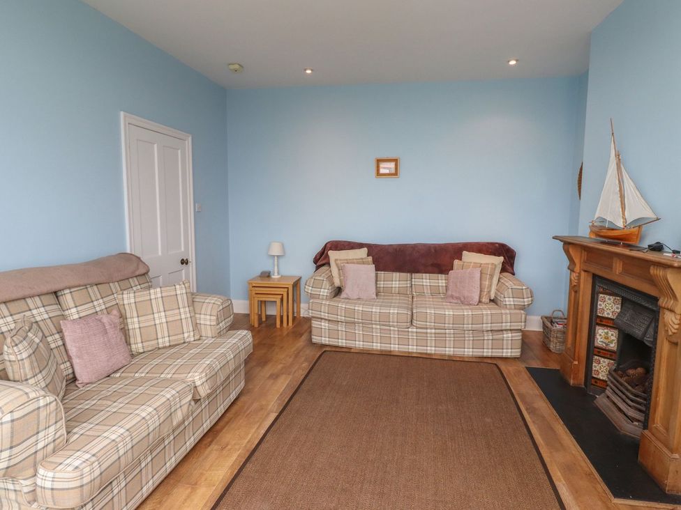 A living room with two sofas and a fireplace at Glen Avon in Seahouses
