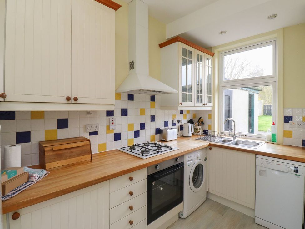A kitchen with modern appliances and a window at Glen Avon in Seahouses