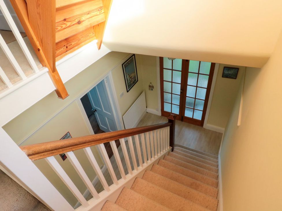 A staircase with a handrail and doors at Glen Avon Seahouses