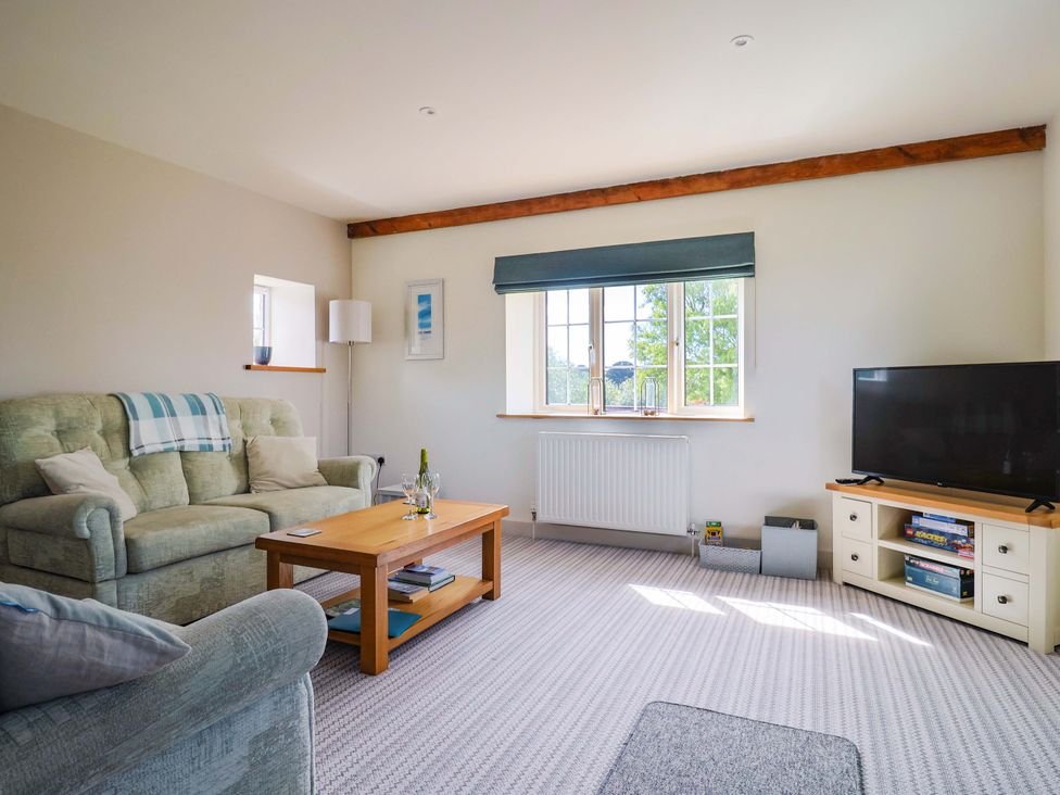 A living room with a sofa and television at The Cottage Middle Westwater Westwater Nr Axminster
