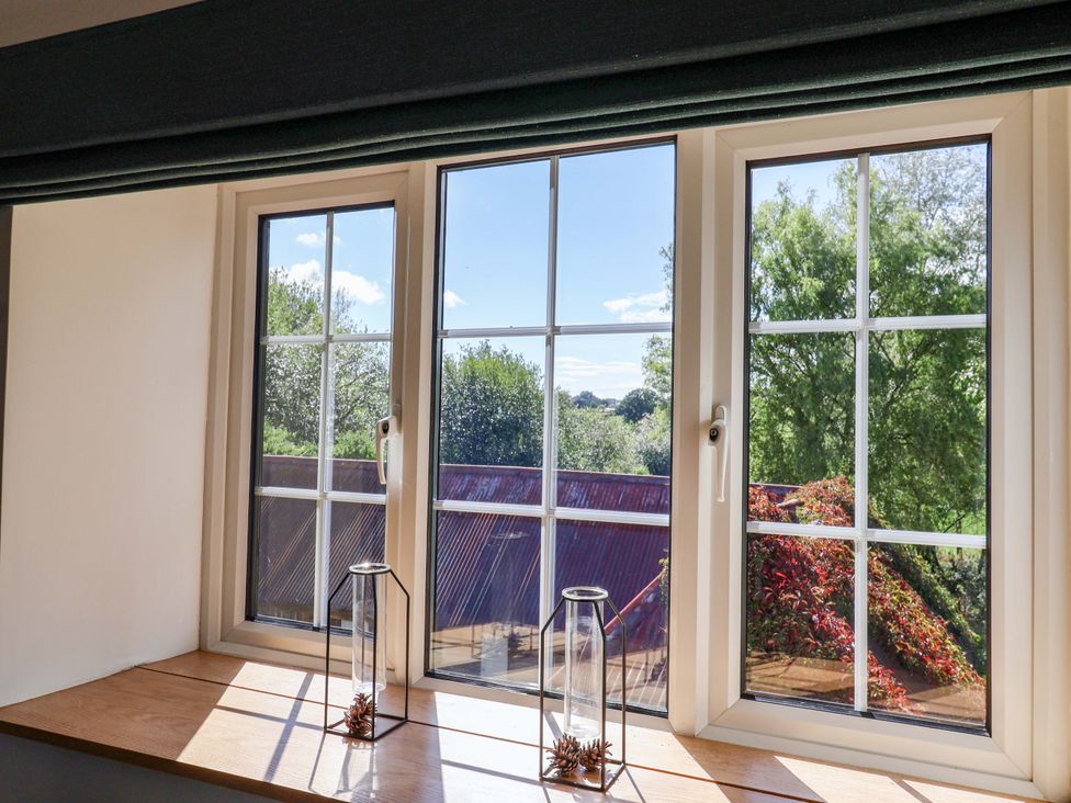 A view through three windows with a wooden ledge at The Cottage Middle Westwater Westwater Nr Axminster