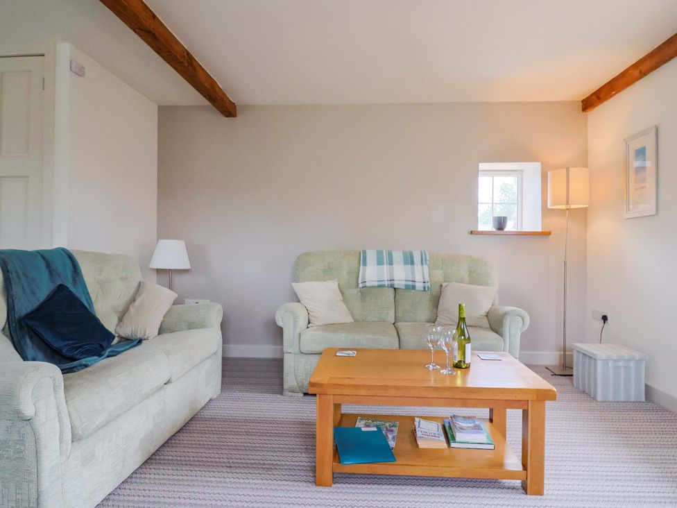 A living room with a sofa and table at The Cottage Middle Westwater Westwater Nr Axminster