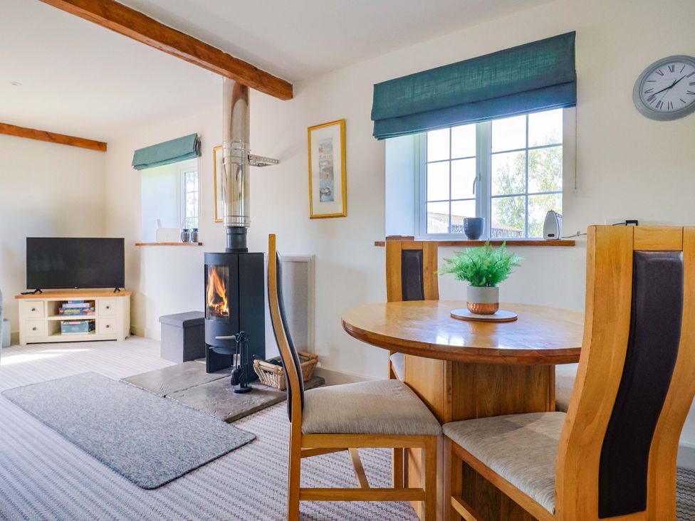 A dining room with a table and chairs at The Cottage Middle Westwater in Westwater Nr Axminster