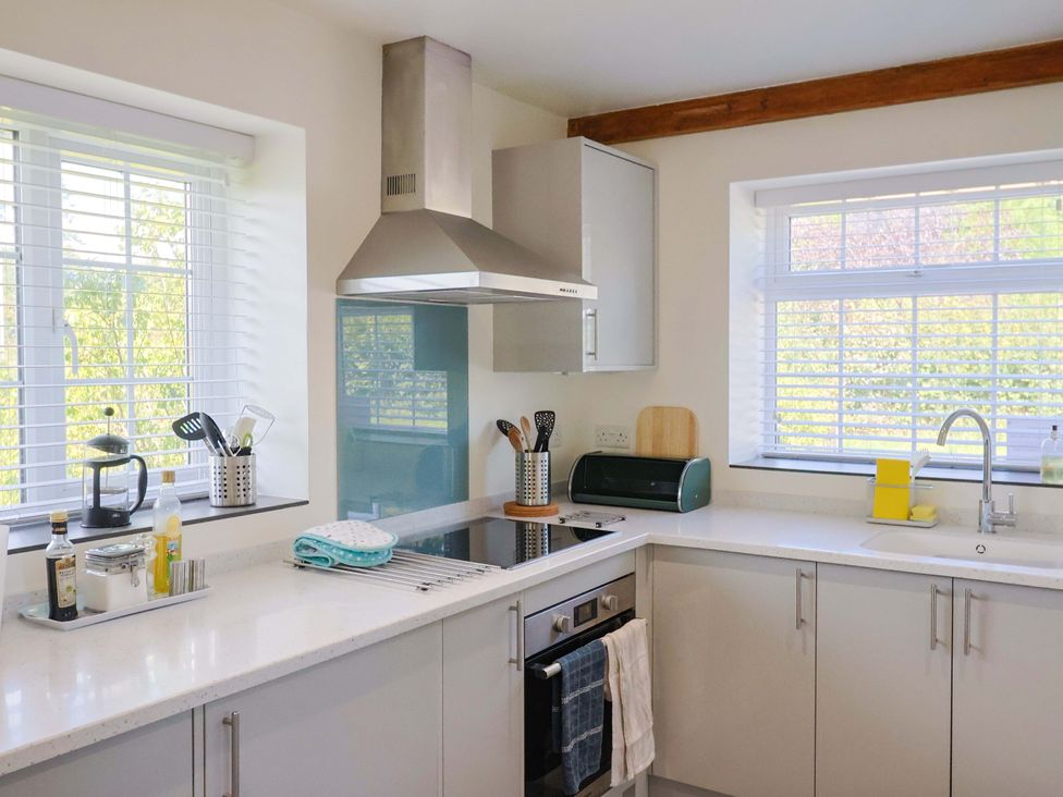 A kitchen with a stove, sink, and utensils at The Cottage Middle Westwater Westwater Nr Axminster