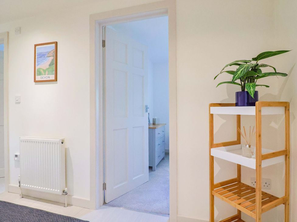 A hallway featuring a plant, a shelf, and a door at The Cottage Middle Westwater in Westwater Nr Axminster