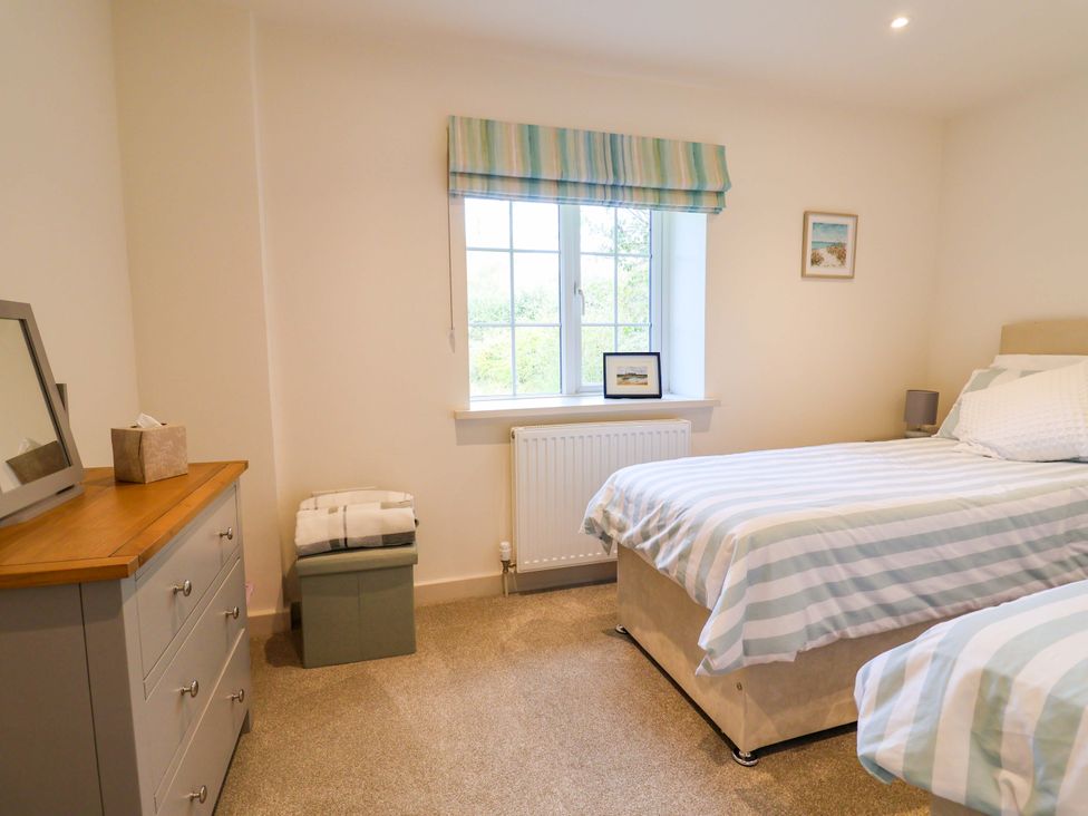 A bedroom with two beds and a dresser at The Cottage Middle Westwater in Westwater Nr Axminster