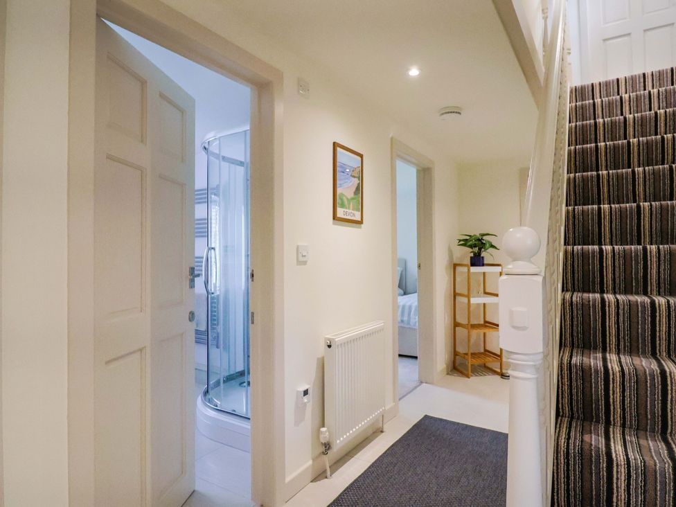 A hallway with stairs and a shower visible at The Cottage Middle Westwater Westwater Nr Axminster