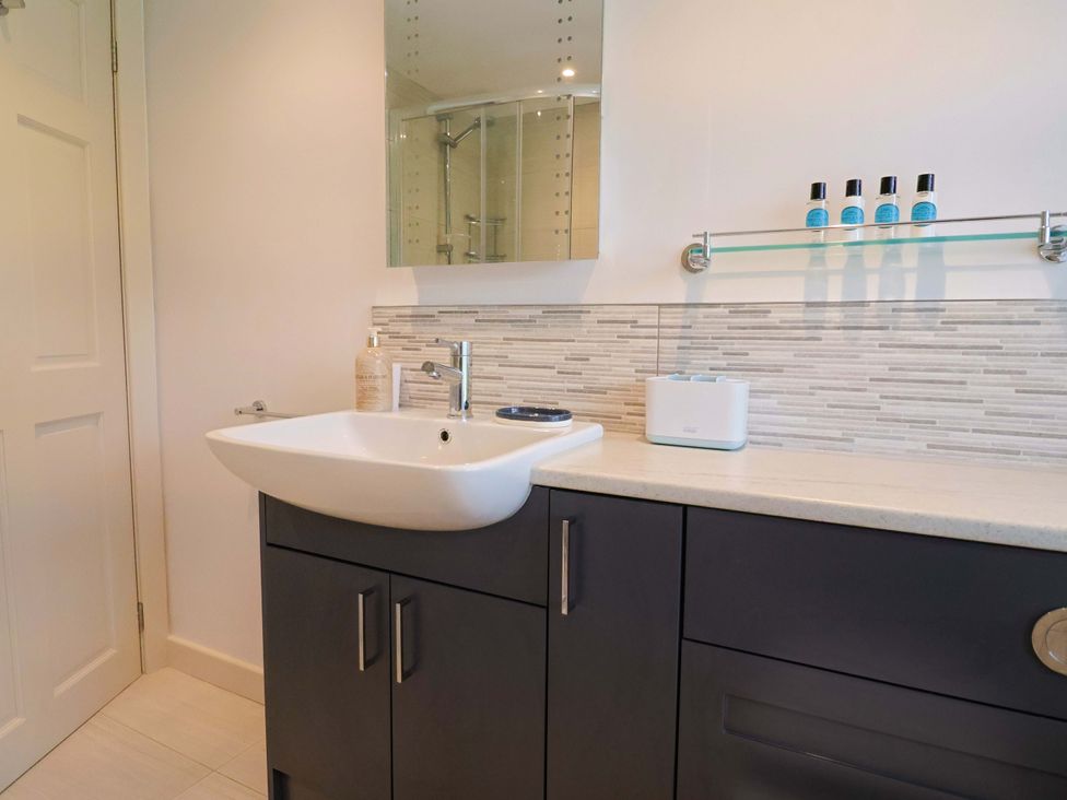 A bathroom with a sink, mirror, and cabinet at The Cottage Middle Westwater Westwater Nr Axminster
