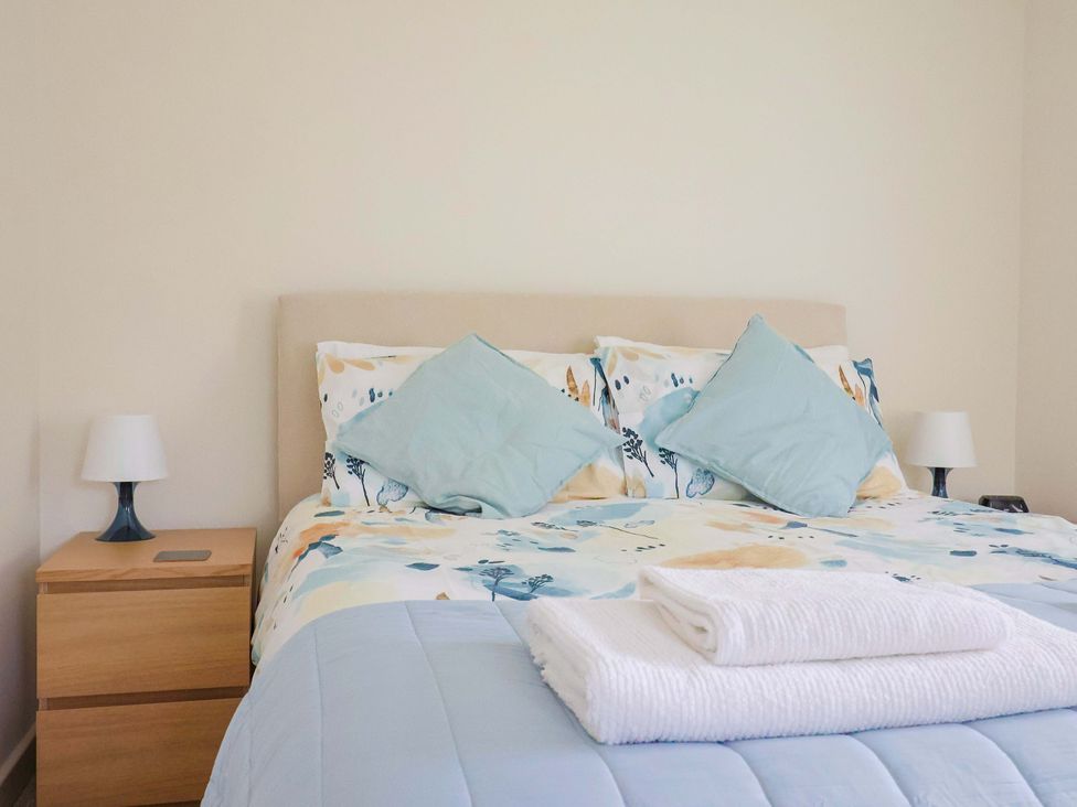A bedroom with a bed, pillows and a nightstand at The Cottage Middle Westwater, Westwater Nr Axminster