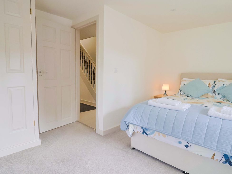A bedroom with a bed and staircase at The Cottage Middle Westwater in Westwater Nr Axminster