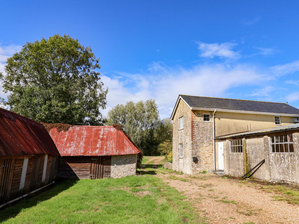 An outdoor view of buildings and trees at The Cottage Middle Westwater in Westwater Nr Axminster