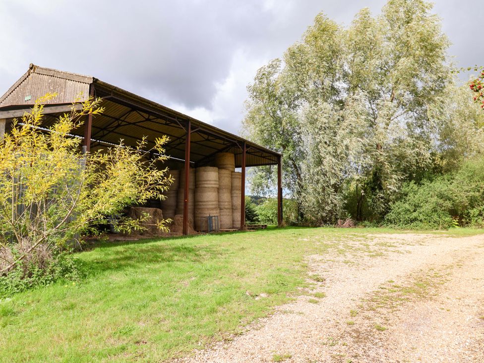 A shelter with hay bales and trees at The Cottage Middle Westwater Westwater Nr Axminster