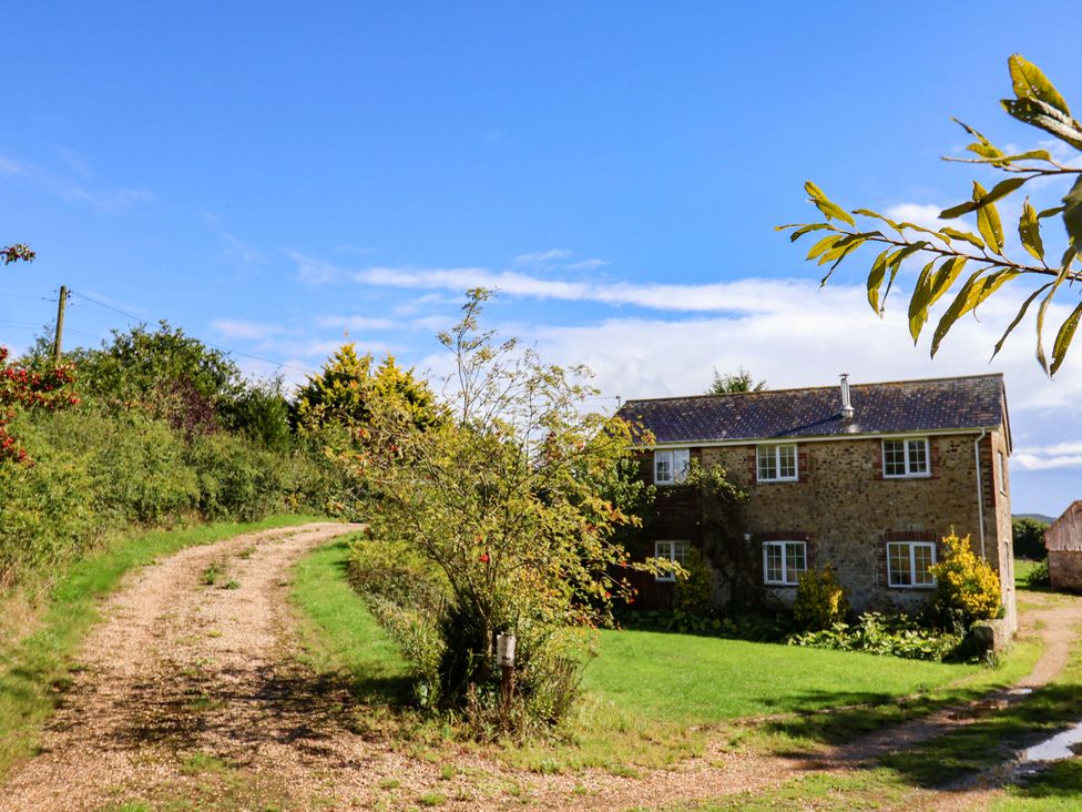 A house beside a gravel path and trees at The Cottage Middle Westwater in Westwater Nr Axminster