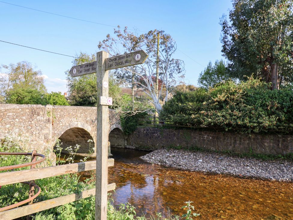 An outdoor scene with a bridge over a river and a signpost at The Cottage Middle Westwater Westwater Nr Axminster