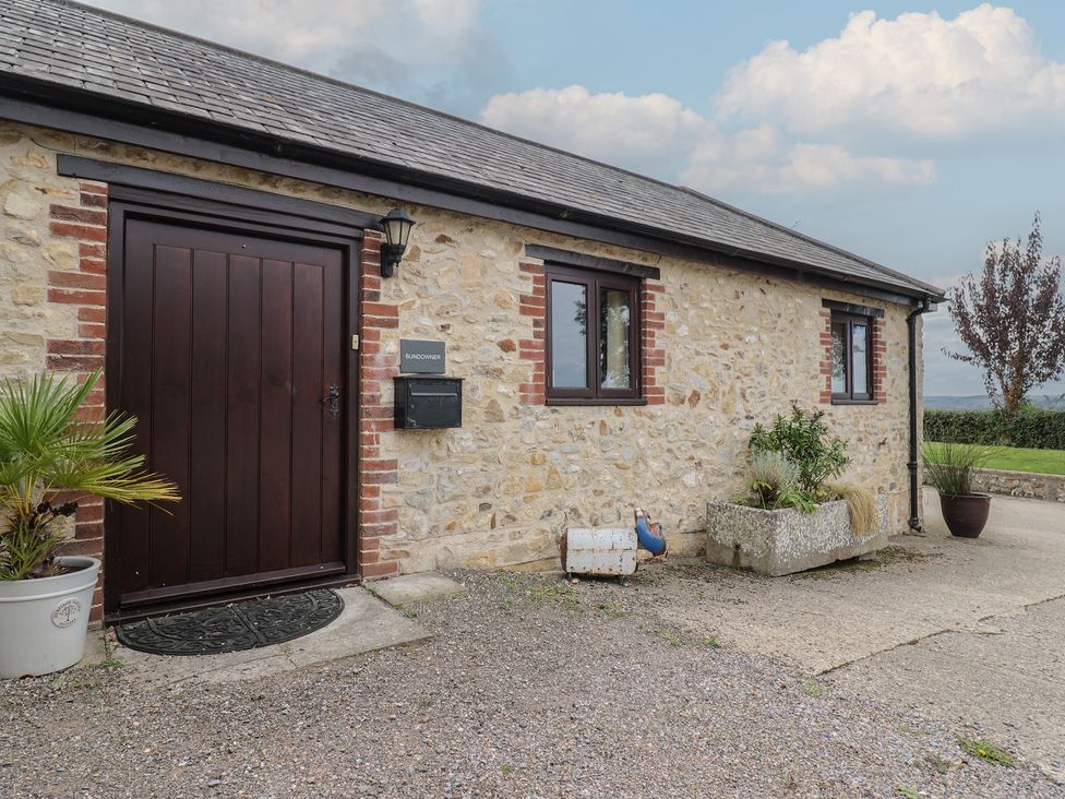 An outdoor view of a stone house entrance at The Sundowner in Wyke Nr. Axminster