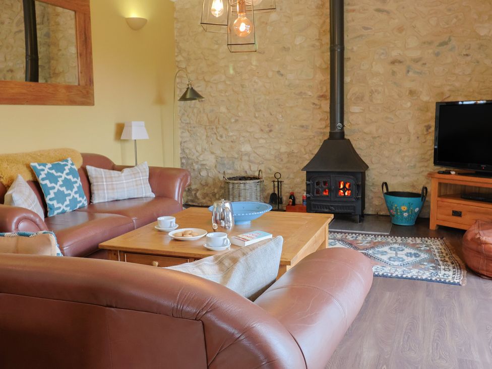 A living room with a sofa and coffee table at The Sundowner in Wyke Nr. Axminster